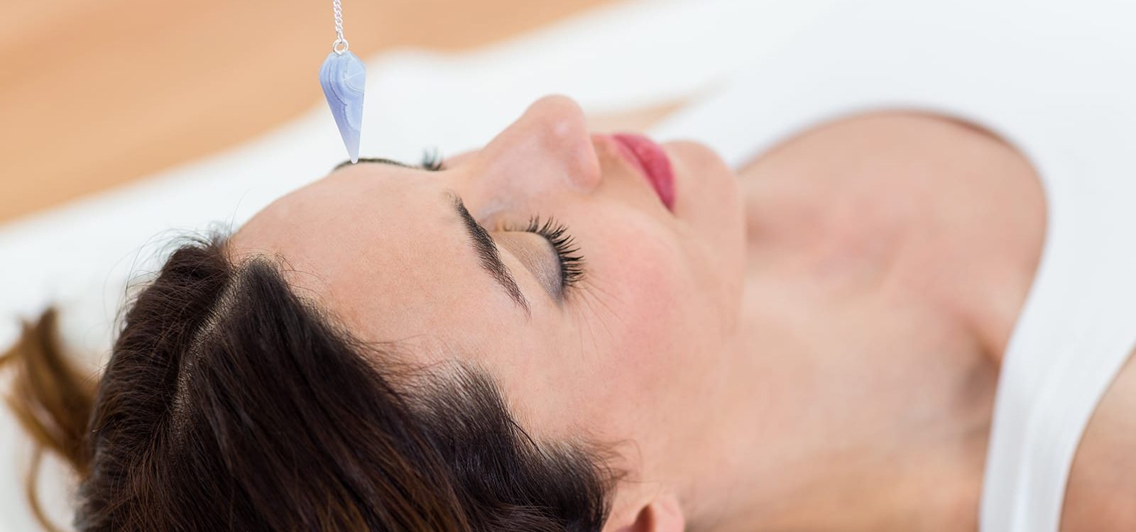 woman-being-hypnotized-while-lying-floor